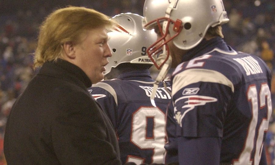 Donald Trump, left, stops to talk to New England Patriots quarterback Tom Brady prior to the start of the game at Gillette Stadium. (AP Photo/Elise Amendola) ORG XMIT: FBO105